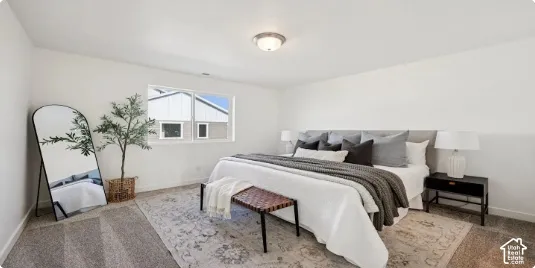 Bright interior with a wall-mounted ceiling light fixture, neutral carpet flooring, and a single window. This home is under construction. Pictures are of a similar home.
