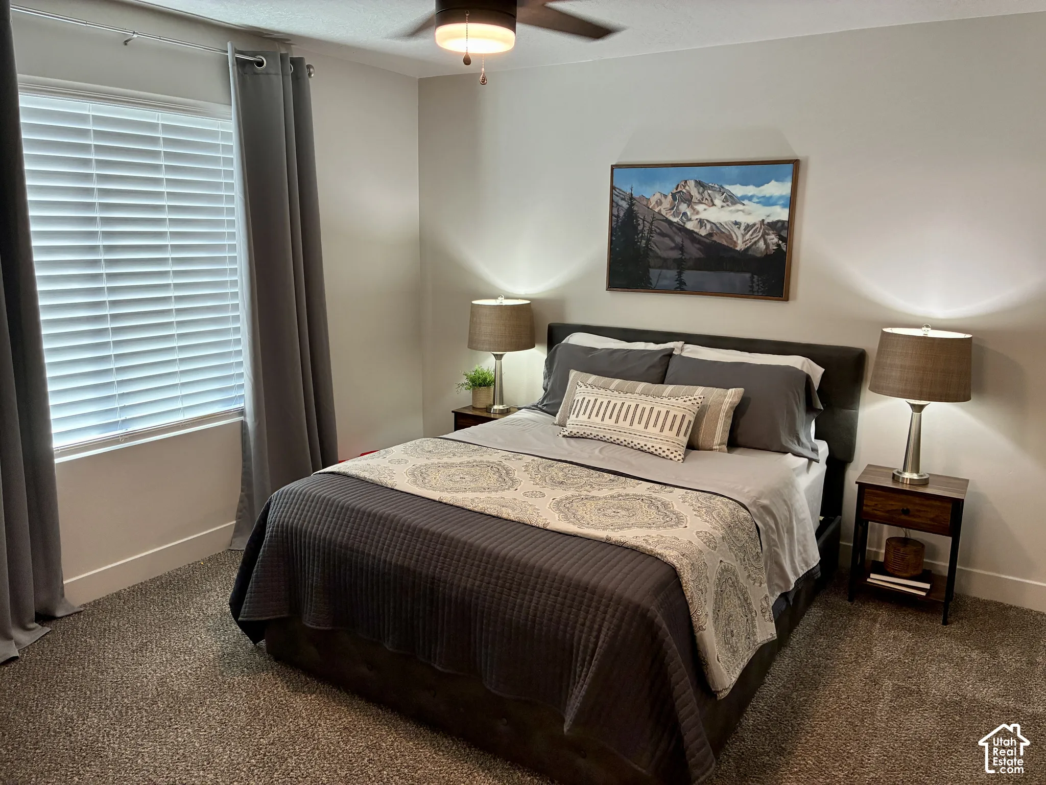 Plush carpeting, window with horizontal blinds, ceiling fan, and light-toned walls