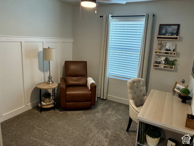 Board and batten wall accent, carpeted flooring, and a ceiling fan with integrated lighting