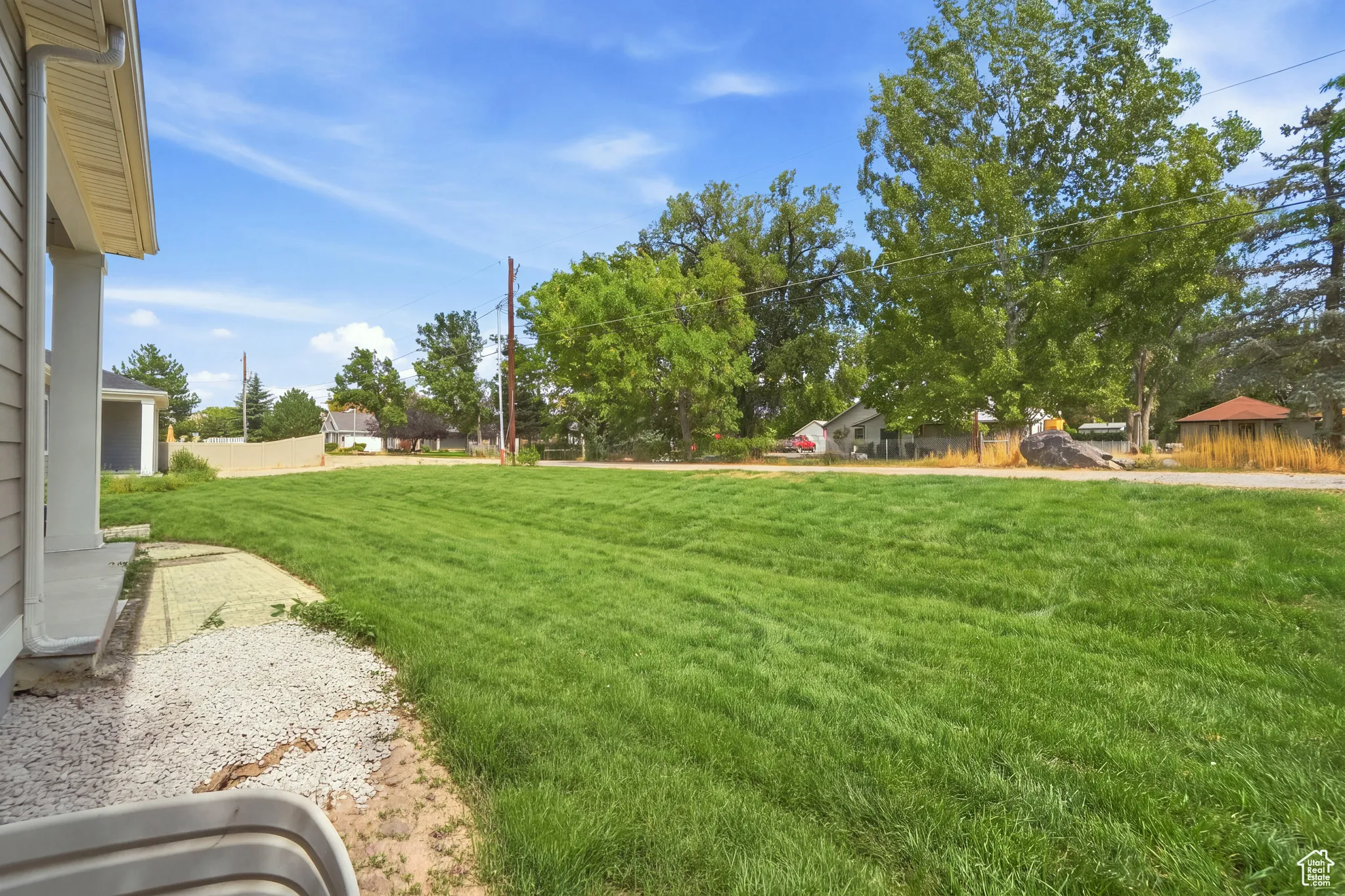Expansive grassy yard with mature trees