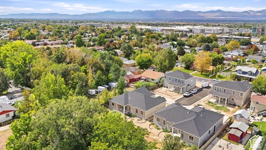 Established neighborhood setting with mature trees and visible mountain range