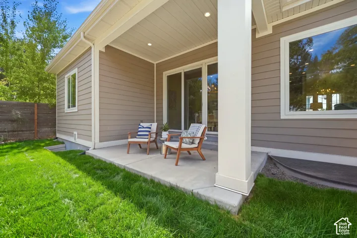 Covered patio with recessed lighting, large glass slider, and a concrete surface
