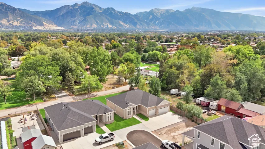 Residential development with newly constructed homes, paved driveways, and landscaped front yards