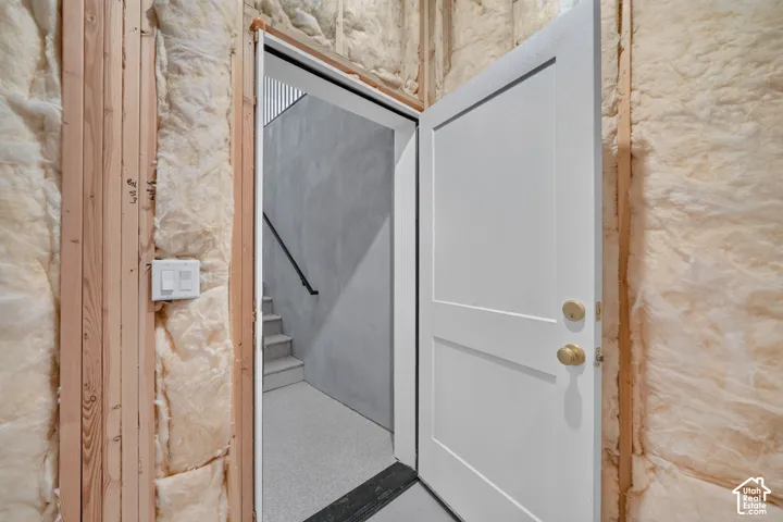 Unfinished wall featuring wood framing and insulation