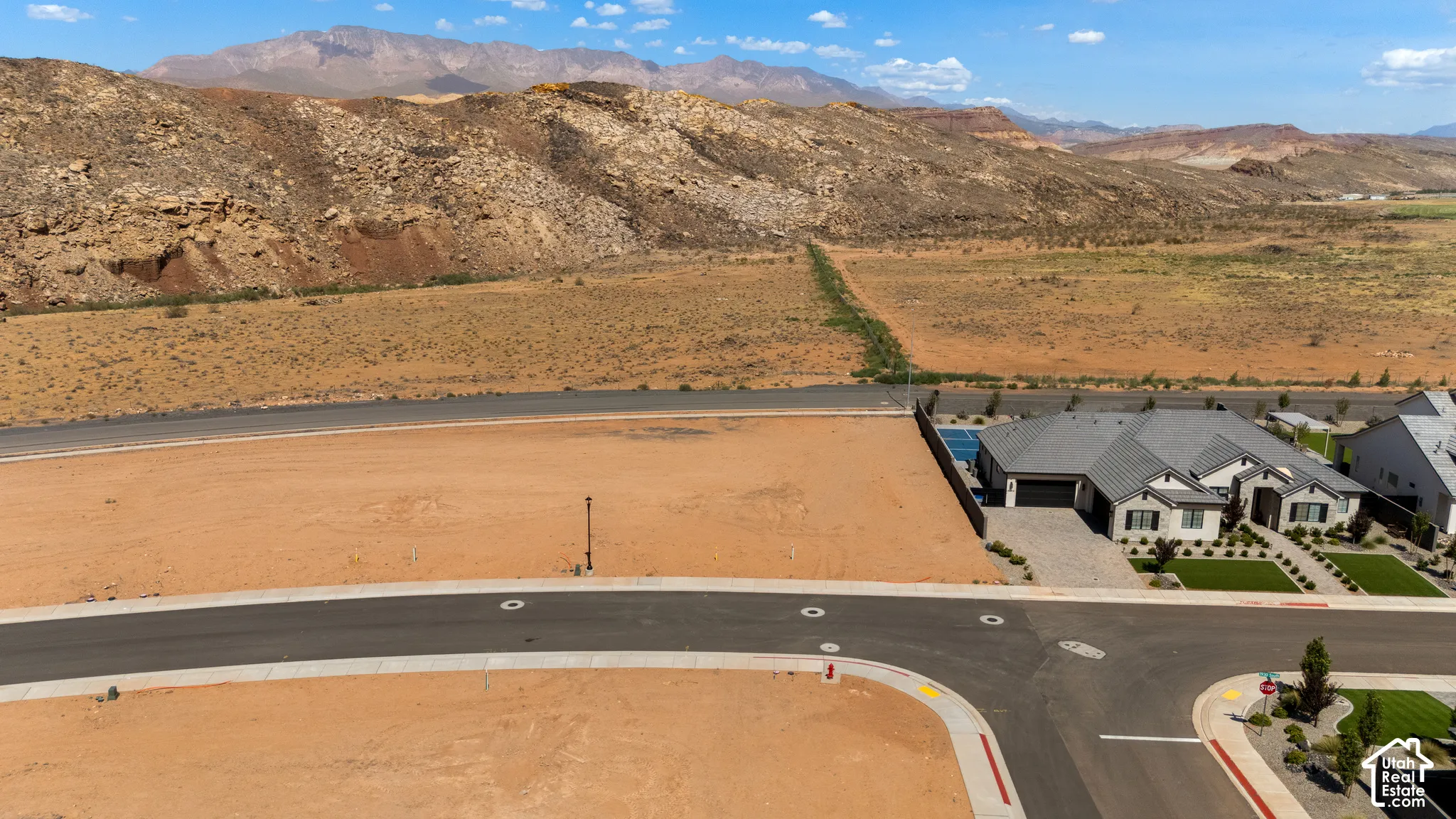 Expansive lot with desert landscaping and mountainous background