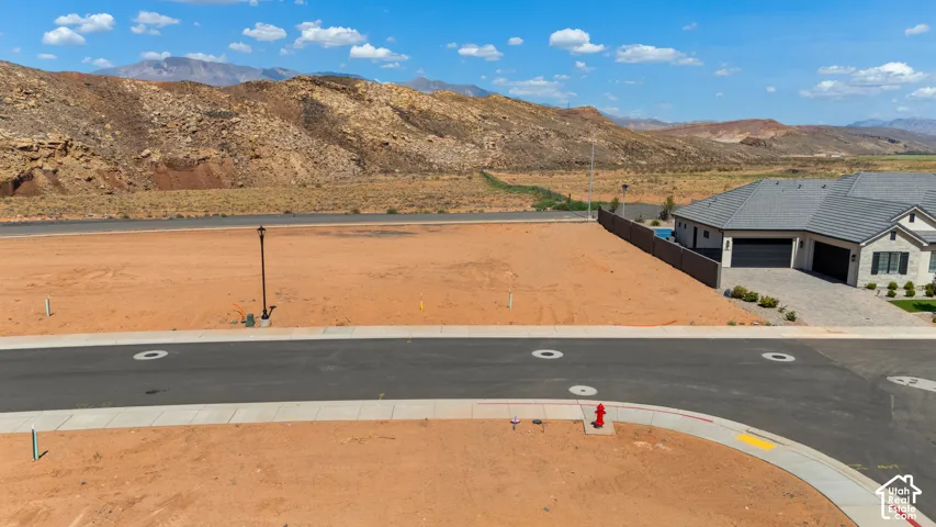 Expansive land parcel with paved street access and established sidewalks