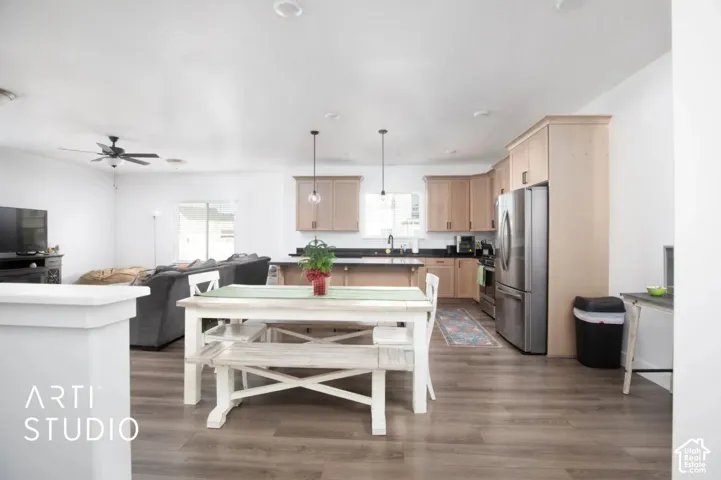 Open-concept living space featuring wood-finish flooring, recessed lighting, and a neutral color palette