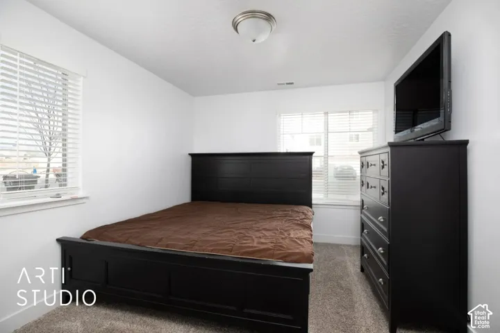 Neutral-toned walls complement the textured carpeting
