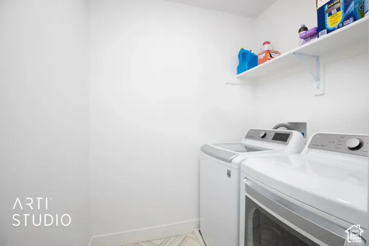 Dedicated laundry area with a white wall-mounted shelf