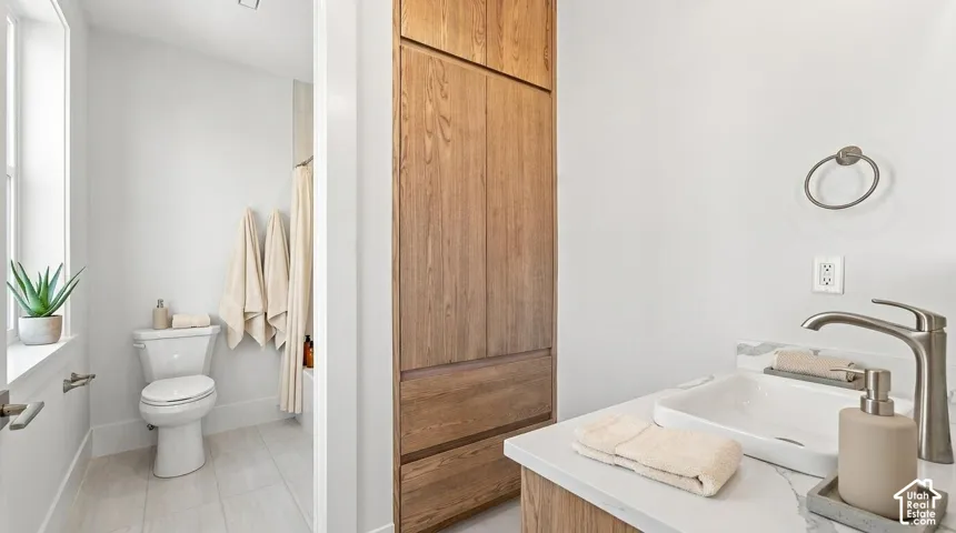 White floating vanity with a rectangular vessel sink, brushed nickel faucet, and wood-finish cabinetry