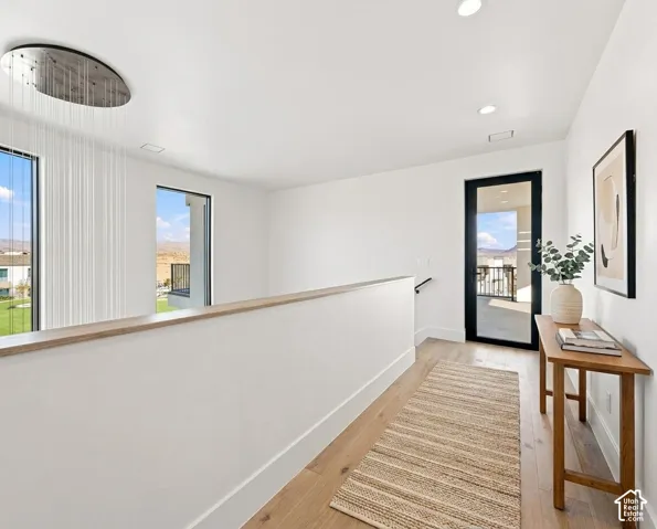 Wood-finish flooring, recessed lighting, and a modern ceiling fixture