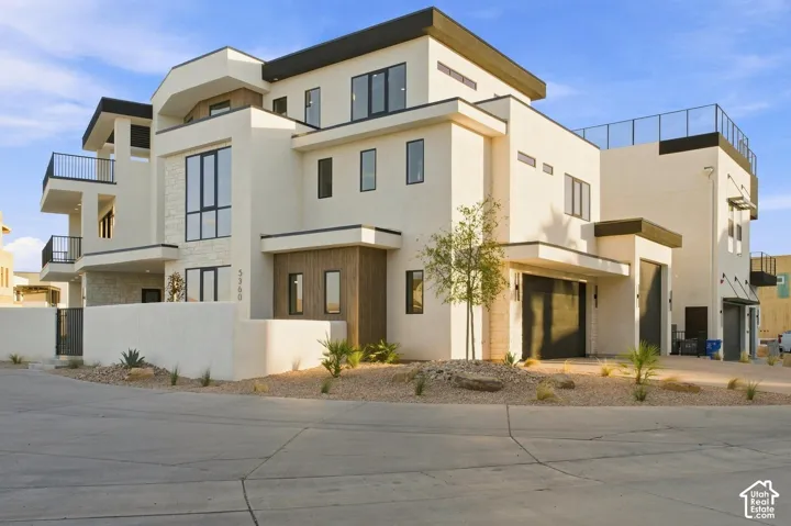 Modern multi-story facade featuring stucco and stone accents