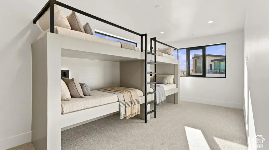 Built-in bunk beds with integrated lighting and black metal ladder accents