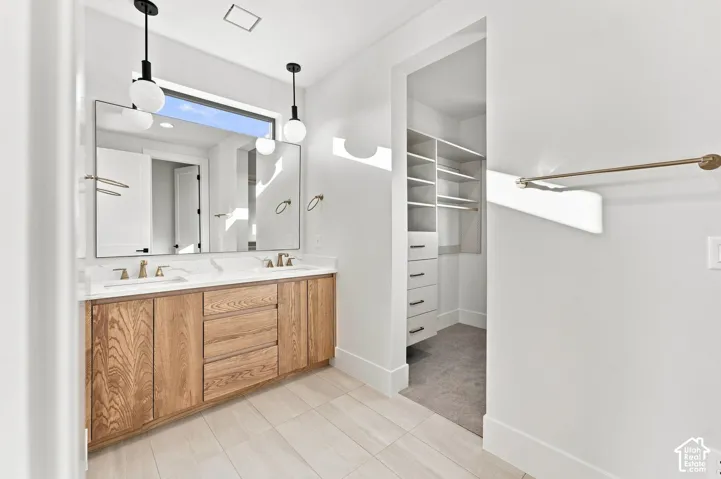 Double vanity with wood-finish cabinetry, dual sinks, and white countertops