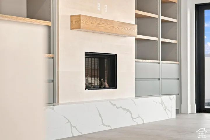 Integrated fireplace with a wood-finish mantel and surround
