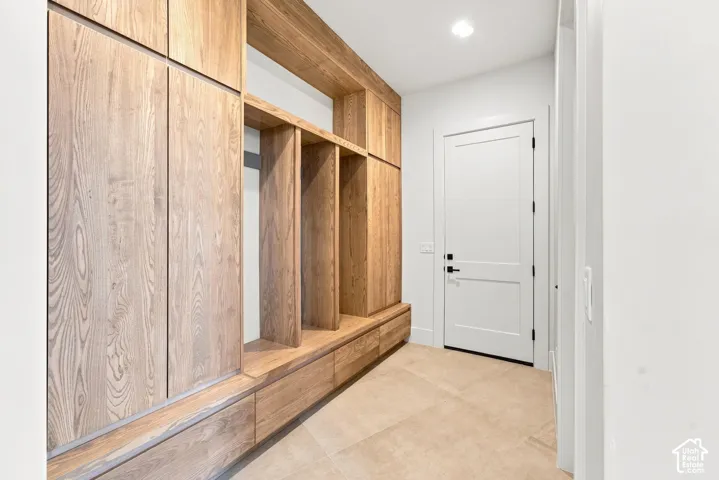 Built-in wood-finish cabinetry and shelving with integrated drawers