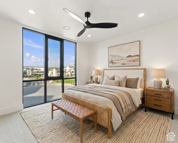 White walls with recessed lighting, black ceiling fan, and large black-framed windows