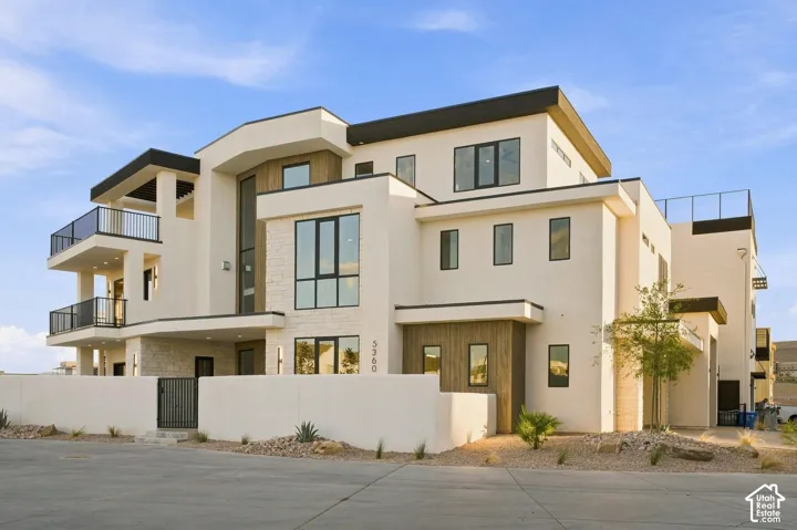 Contemporary multi-story exterior with a stucco finish and stone accents