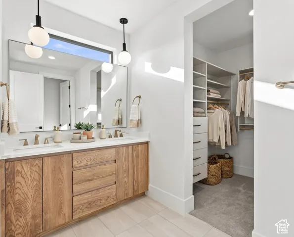Dual vanity with wood-finish cabinetry, white countertop, and rectangular undermount sinks