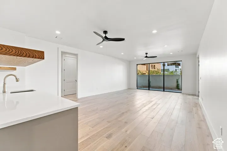Wood-finish flooring throughout, complemented by recessed lighting and ceiling fans