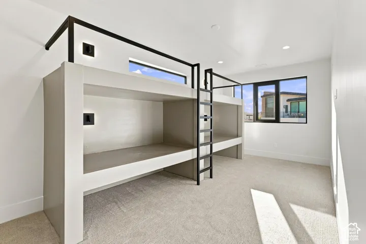 Built-in bunk beds with integrated lighting, a contemporary window, and recessed ceiling lights