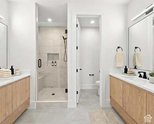 Dual wood-finish vanities with white countertops and undermount sinks