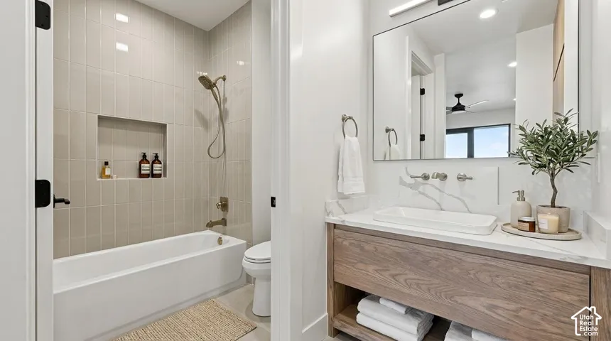 Bathroom featuring a floating wood-finish vanity with a rectangular vessel sink, wall-mounted faucet, and a large mirror