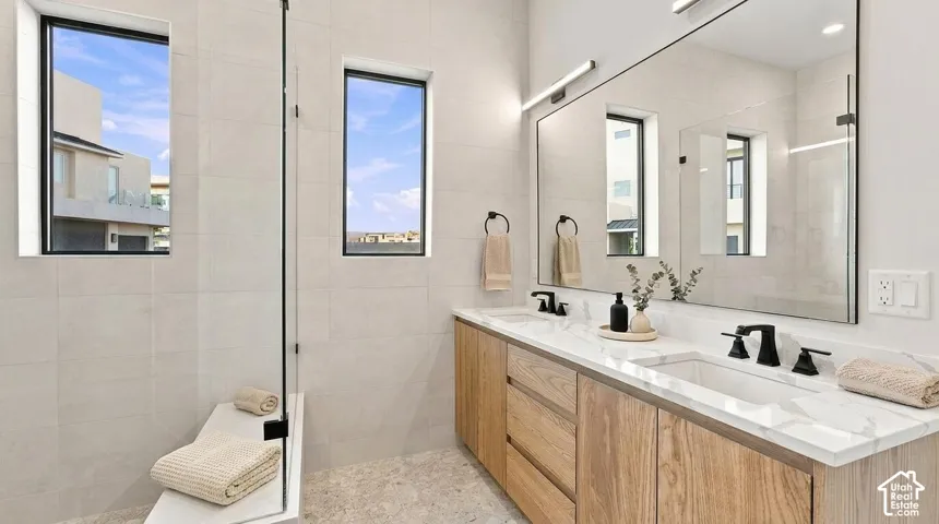 Double vanity with a light wood-finish base and white countertop