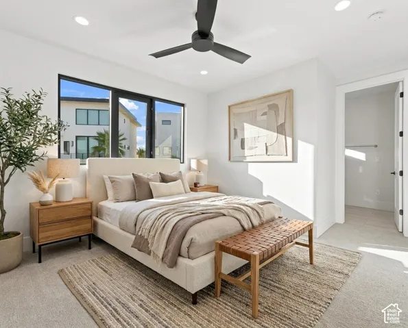 Recessed ceiling lighting, modern black ceiling fan, large black-framed windows, carpeted flooring, and built-in closet with hanging rod