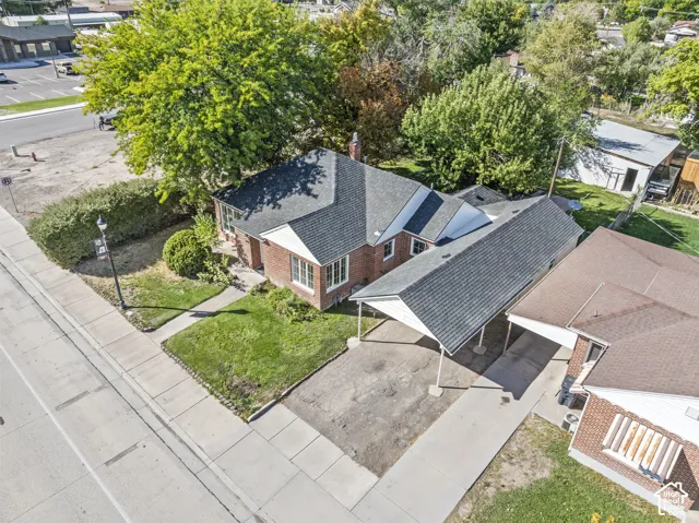Brick exterior with dark shingle roofing