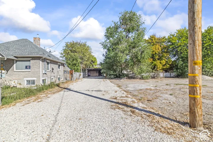 Gravel driveway leading to a detached structure
