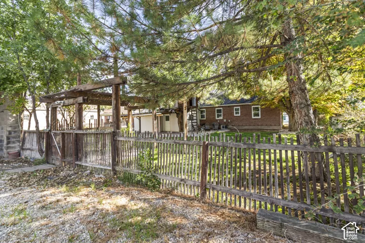 Fenced perimeter with wooden picket fencing and gate