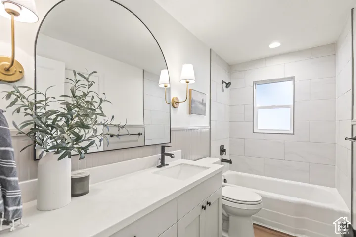 White vanity with a single basin and matte black faucet