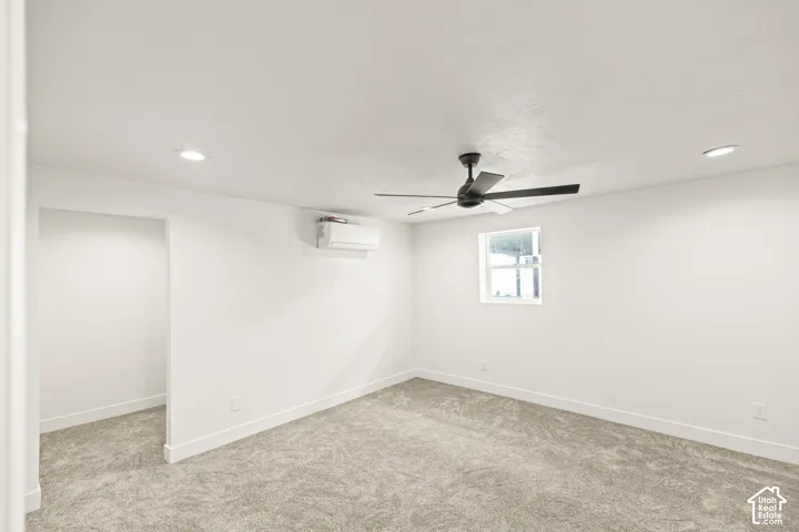 Carpeted room featuring a white ceiling, recessed lighting, and a black ceiling fan