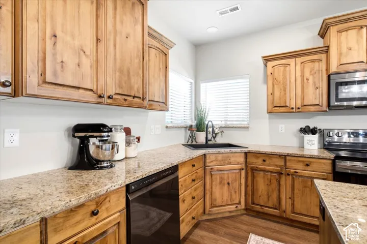 Natural wood cabinetry with dark hardware