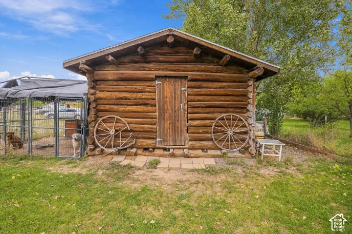 Log cabin structure with a wood shingle roof and a single wood door