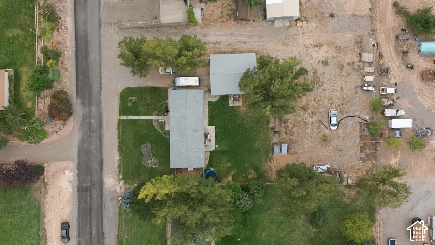 Expansive lot featuring two structures, established trees, and a grassy area