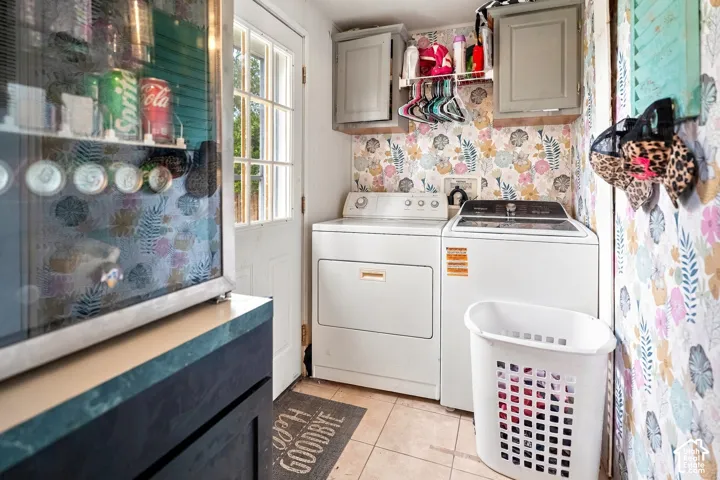 Laundry area featuring built-in cabinetry, upper shelving, and a paneled exterior door