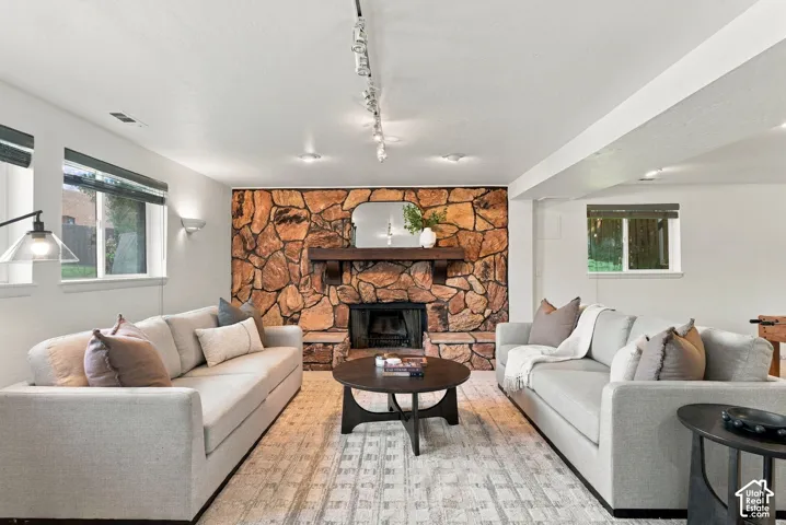 Stone accent wall with a fireplace and wood mantel