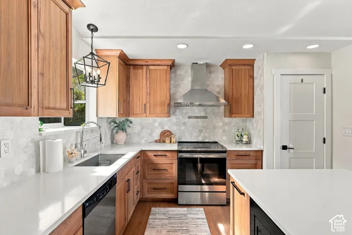 U-shaped kitchen featuring wood cabinetry, white countertops, a mosaic tile backsplash, stainless steel appliances, and recessed lighting