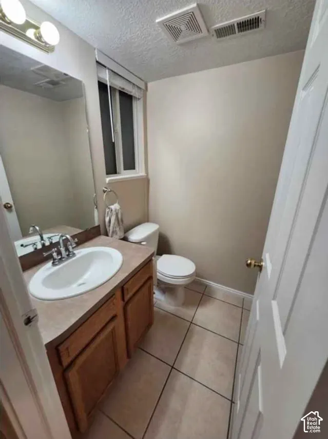 Vanity with an integrated sink, wood-finish cabinetry, and a full-width mirror