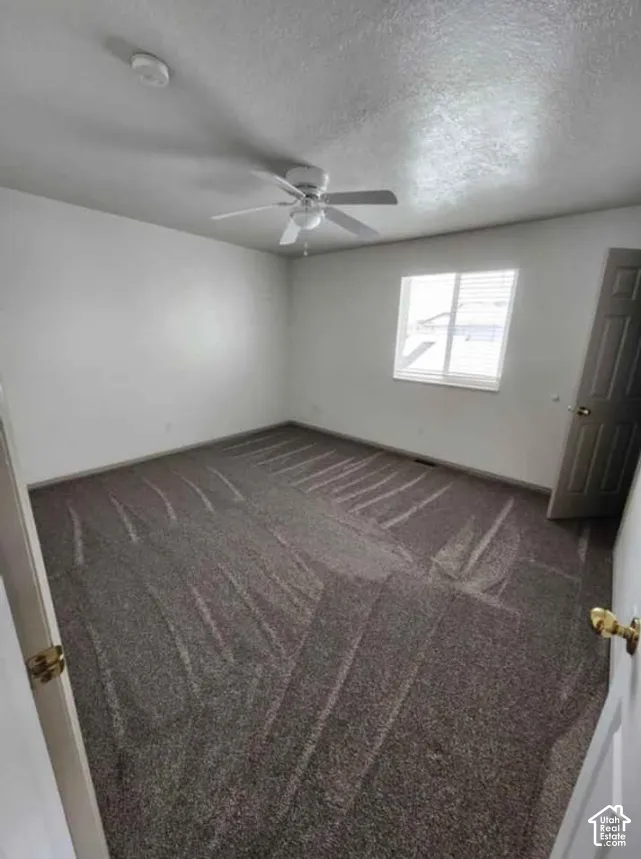 Recessed window with blinds, ceiling fan with integrated lighting, and neutral tone carpet flooring