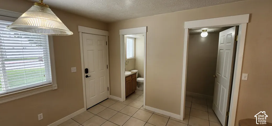 Tiled flooring throughout, white paneled doors, and updated trim work