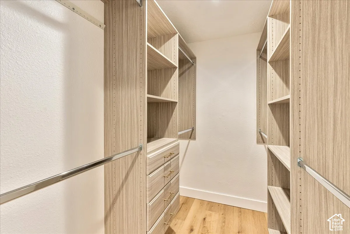 Custom closet system with wood-finish shelving and built-in drawers