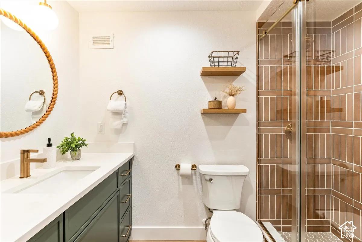 White vanity countertop with an integrated sink and brass-finish faucet