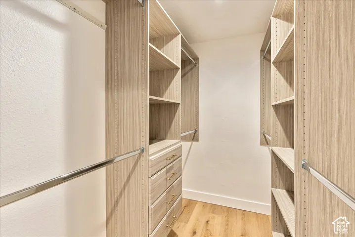 Custom closet system with wood-finish shelving and built-in drawers