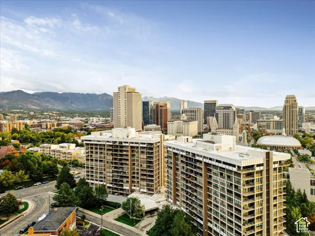 Urban skyline with multiple high-rise buildings and a mountain backdrop