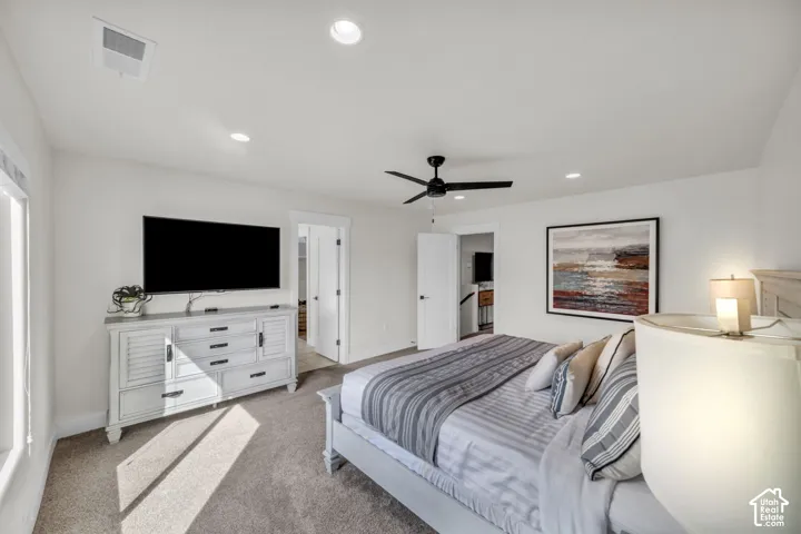 Recessed ceiling lighting, ceiling fan, carpet flooring, and white interior doors