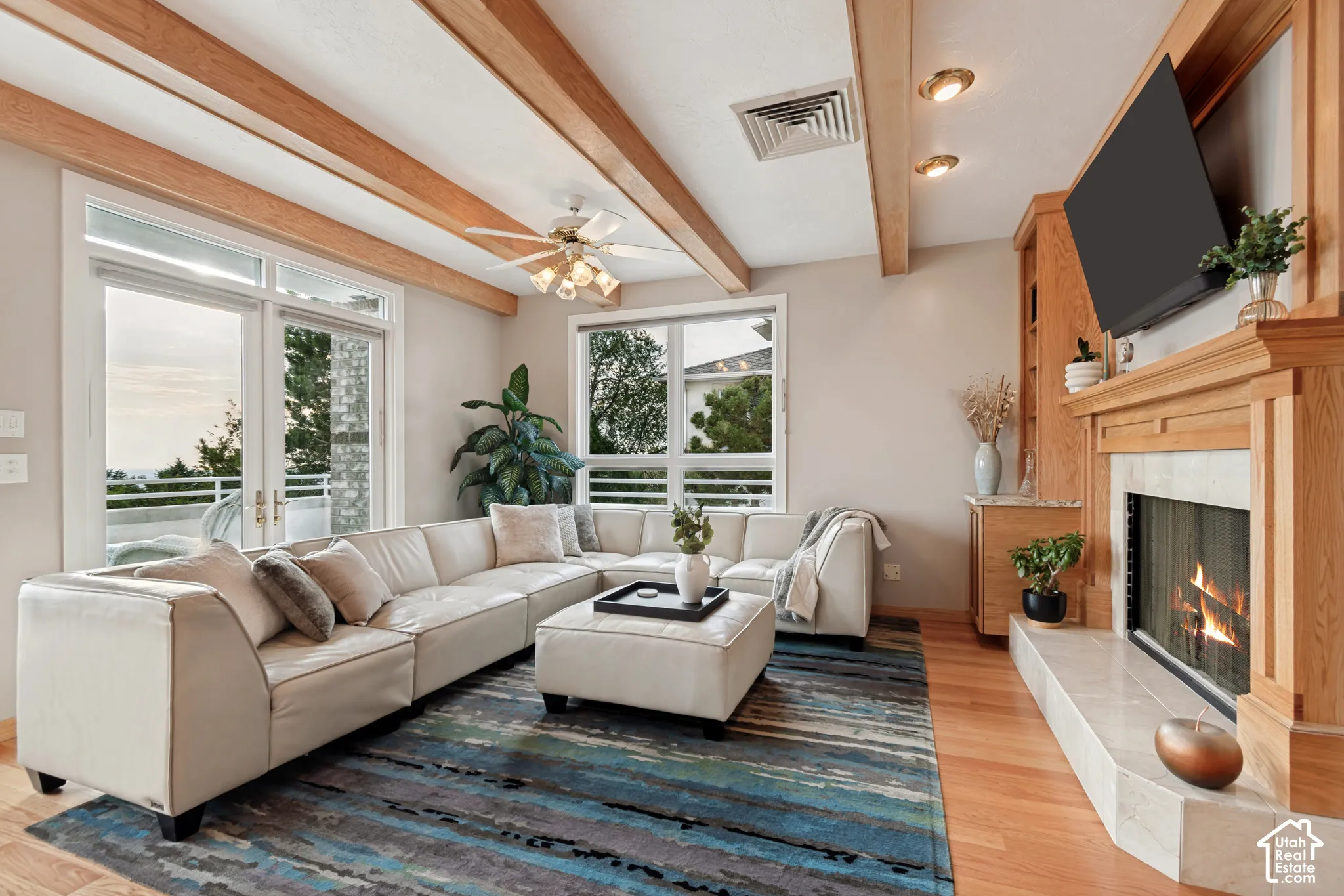 Living room with wood beams, hardwood floors &fireplace. Valley views out the windows.