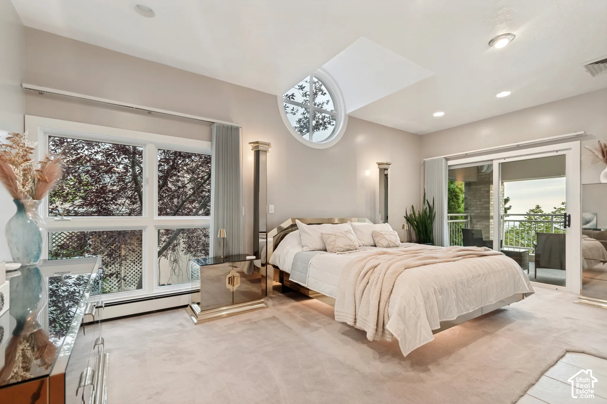 Primary bedroom with private balcony and valley views out of windows